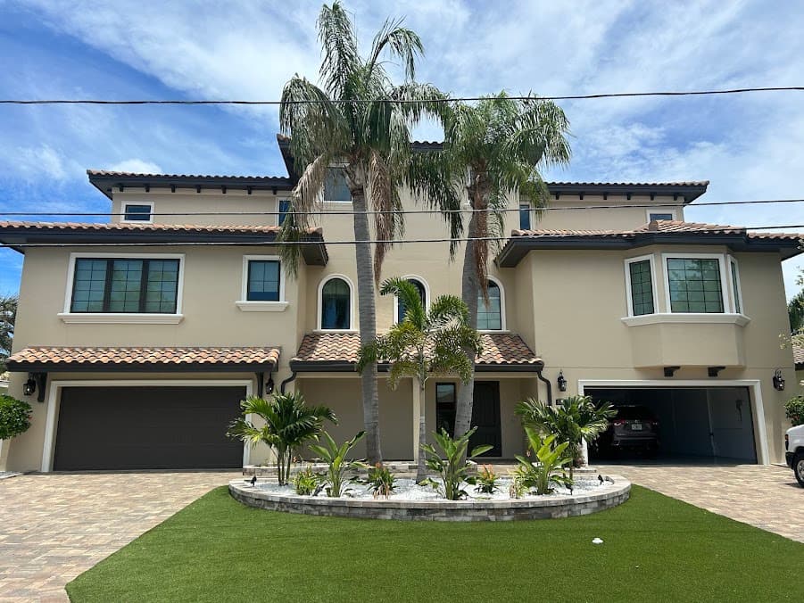Two-story home with new exterior paint, driveway, and landscaped front yard.